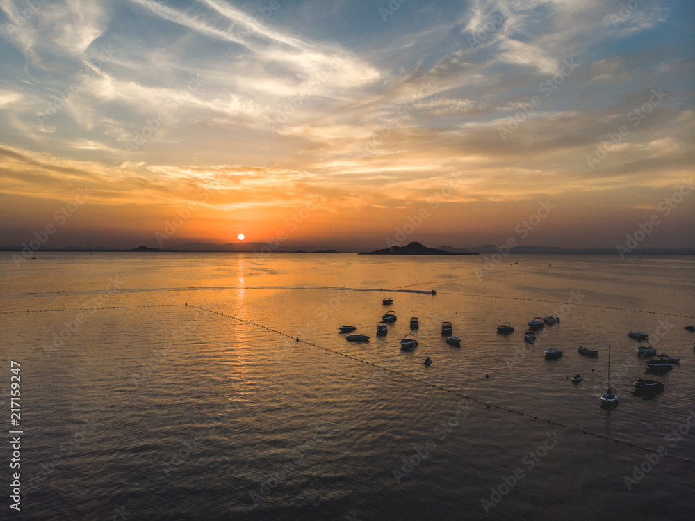 Sunset at La Manga del Mar Menor, Murcia, Spain, Summer 2018. Boats and golden sunset at mar menor. Golden hour dramatic sunset. Drone arial shoot from the sky.