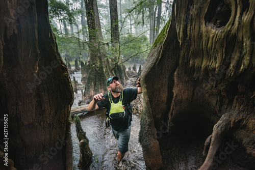 A male kayaker explores an old growth cypress swamp in the Black River, NC