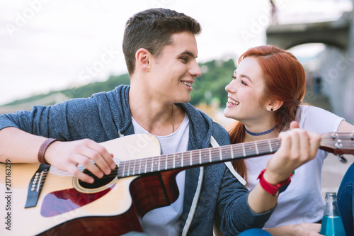 Beautiful melody. Joyful happy woman looking at her boyfriend while enjoying the melody © Viacheslav Yakobchuk