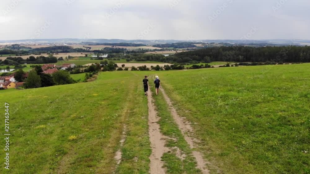 Two guys tracked by a drone from behind Two guys tracked by a drone from behind