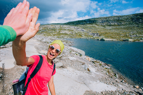 Εκτύπωση καμβά The girl going up at mountains on the background of a Norway landscape