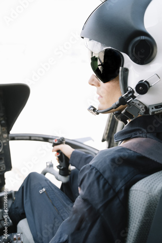 Attractive woman pilot sitting in the helicopter