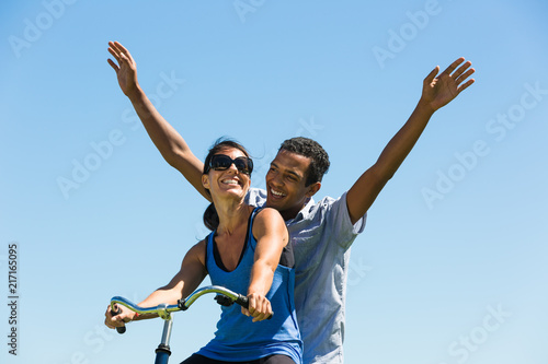 Young Happy Couple Share a Bicycle