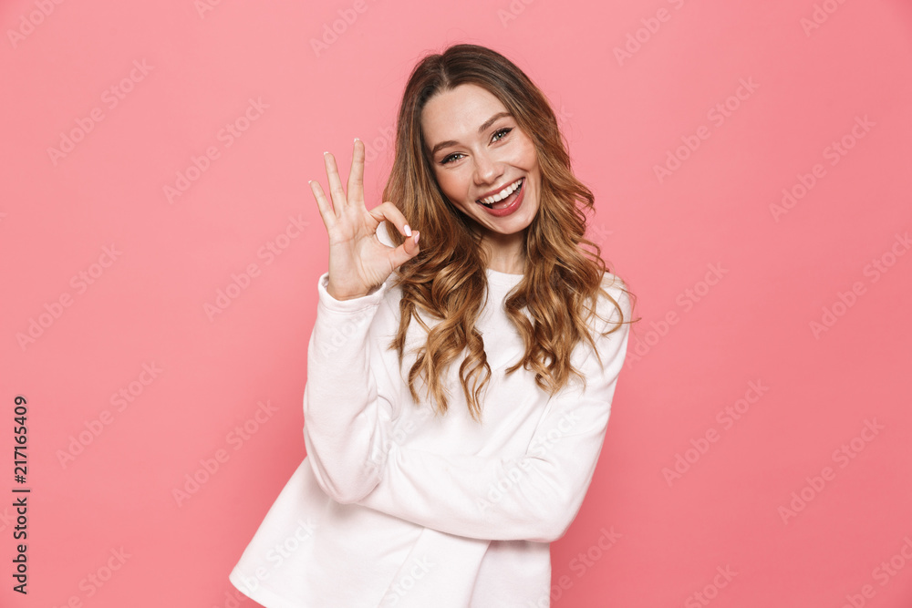 Portrait of a lovely young casual girl showing ok gesture Portrait of a lovely young casual girl showing ok gesture