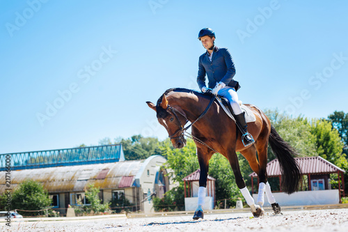 Promising equestrian. Young promising equestrian feeling extremely exhausted after long training © Viacheslav Yakobchuk