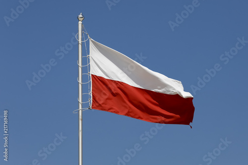 The Polish flag against the background of the sky