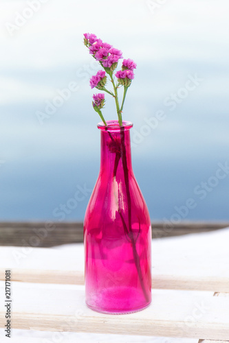 Flower in vase with river background