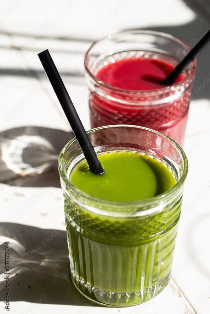 Red and green detox juice glass with copy space.