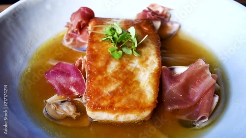 Seared tuna steak, pan fried with prosciutto scallops and beautiful clam broth. Served at Michelin star restaurant. photo