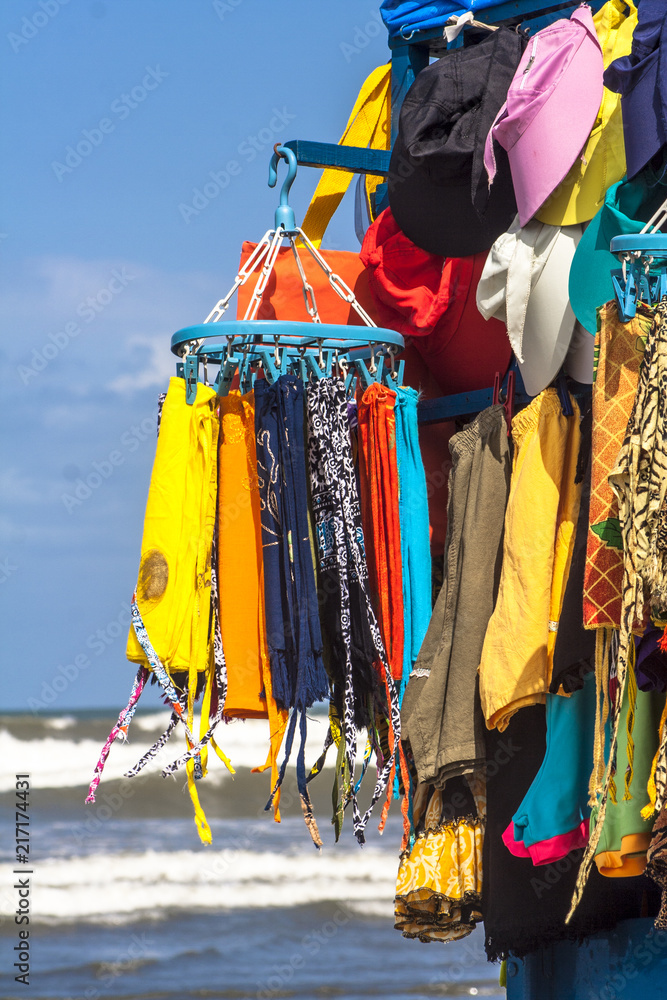 Street vendor of clothes, swimsuits, bikinis and cangas on a beach in Brazil
