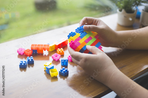 People are playing on a rainbow heart Blocks toys. In vintage style.