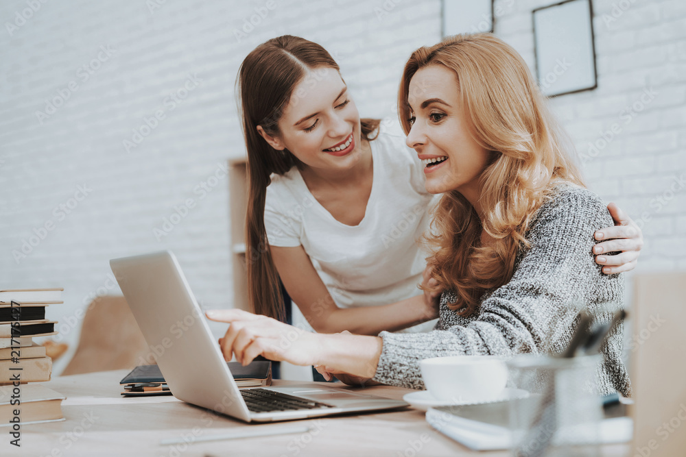 Mother and Daughter Watching into Laptop at Home. Mother and Daughter Watching into Laptop at Home.