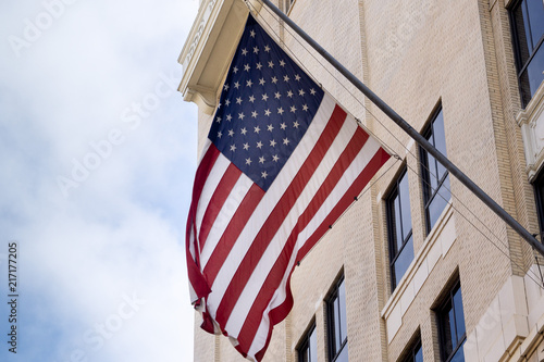 US flag displayed from traditional Los Angeles downtown city building.