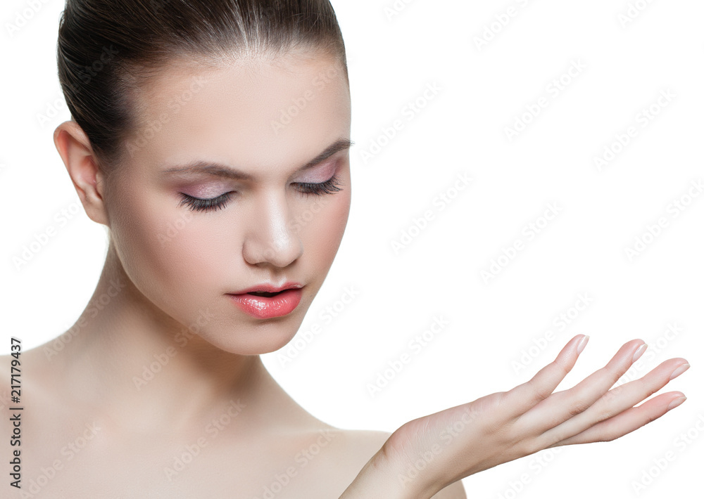 Cute young woman showing empty copy space on the open hand isolated on white background. Female face closeup. Skincare and wellness concept. Presenting your product Cute young woman showing empty copy space on the open hand isolated on white background. Female face closeup. Skincare and wellness concept. Presenting your product