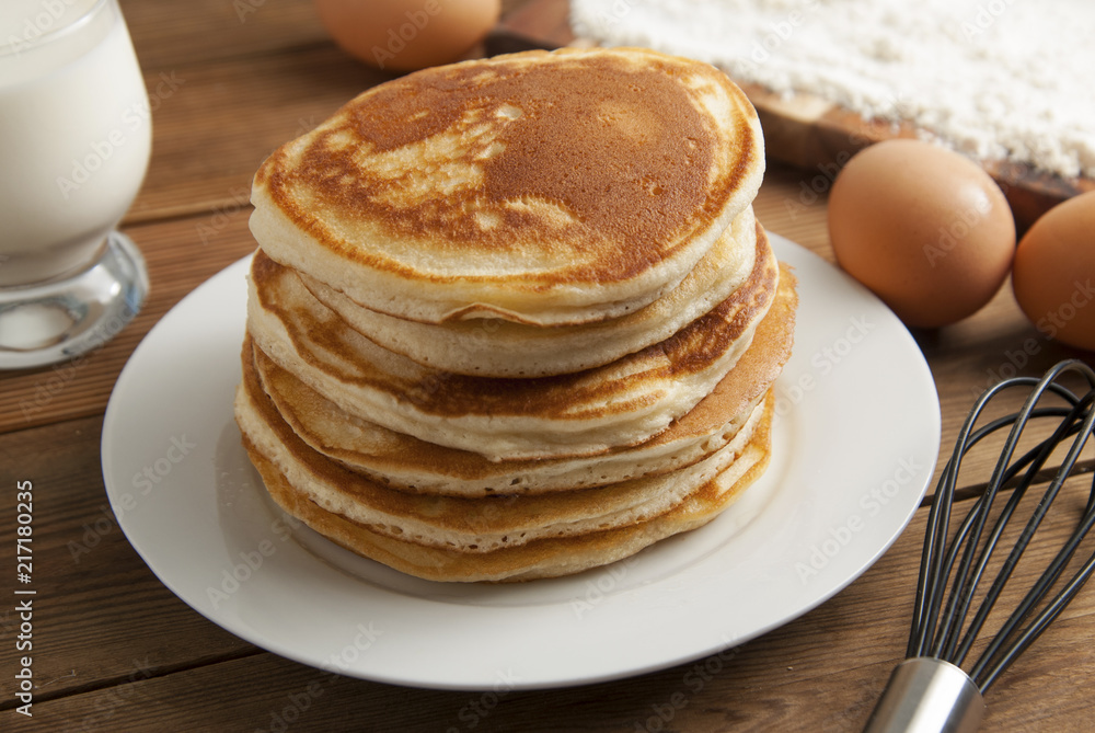 Cooking pancake on wooden background top view ingredients for making pancakes: milk, eggs, flour. Cooking pancake on wooden background top view ingredients for making pancakes: milk, eggs, flour.