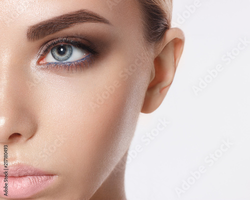 Close-up portrait of sexy young woman with beautiful blue eyes. Woman beauty face portrait with healthy skin. Portrait of beautiful young woman looking at camera. Natural beauty concept