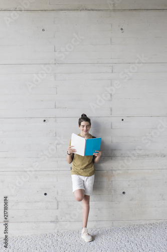 student with backpack and books on the background wall