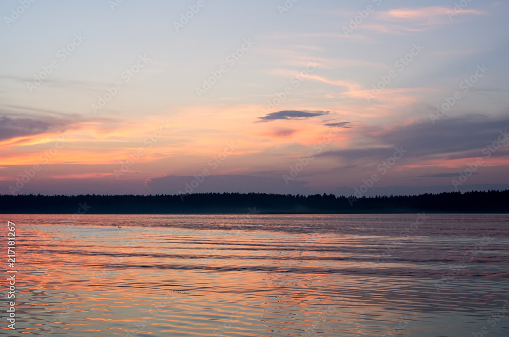 Fototapeta premium Sunset on the lake. Beautiful sunset nature. Evening landscape. Clouds over the lake. The horizon at sunset. Sea, lake at sunset.