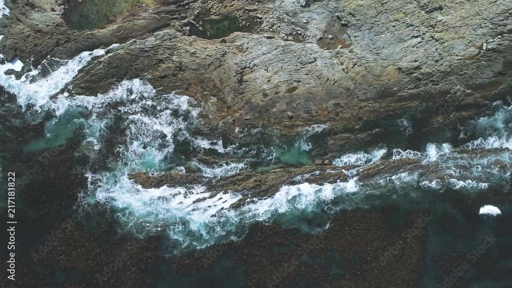 Top down drone shot of waves crashing into rocks on Hermanus coastline, South Africa Top down drone shot of waves crashing into rocks on Hermanus coastline, South Africa