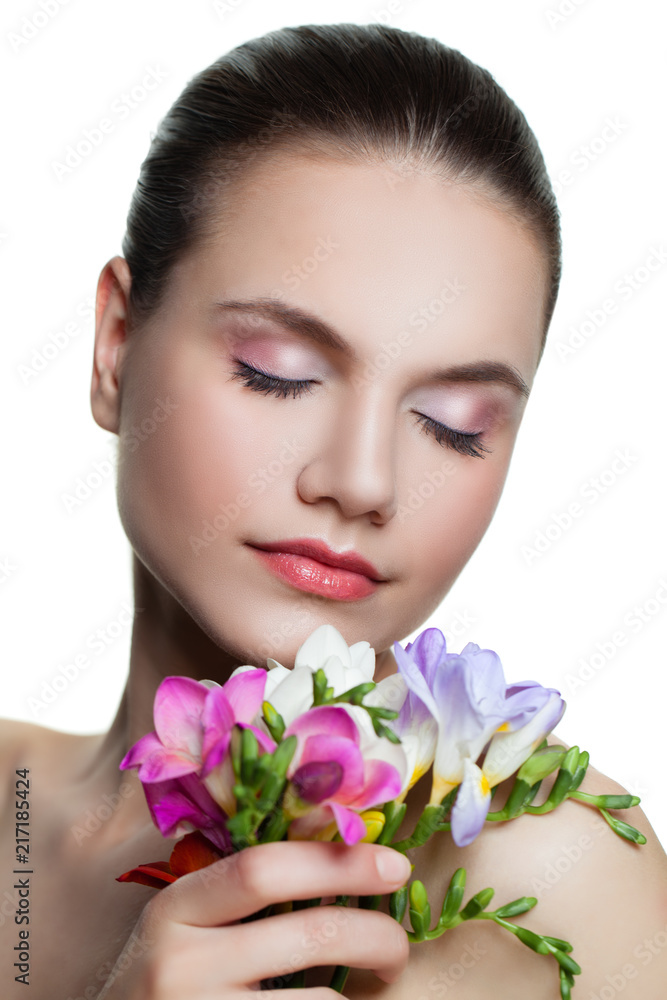 Young woman with flower, face closeup. Facial treatment, cosmetology, skincare and spa concept