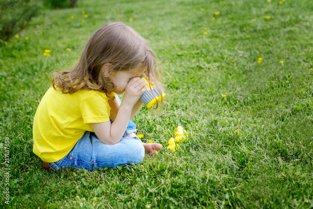 cute little girl playing with rubber duck and plastic binoculars outdoors. beautiful baby having fun with a toy duckling. home development of children. selective focus. cute little girl playing with rubber duck and plastic binoculars outdoors. beautiful baby having fun with a toy duckling. home development of children. selective focus.