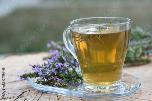 Cup of  fresh natural tea on wooden table.  Thymus serpyllum natural tea, Breckland Thyme  with cup of tea