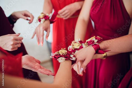 bride's friends show each other manicure. Green dresses. concept wedding, friendship and fashion. Girlfriends show off manicure photo