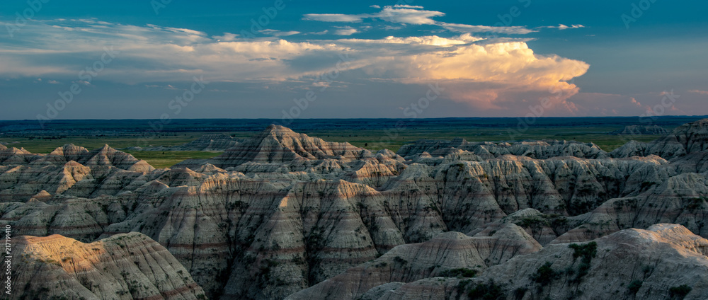 Sunset over Badlands National Park with thunderhead in the background