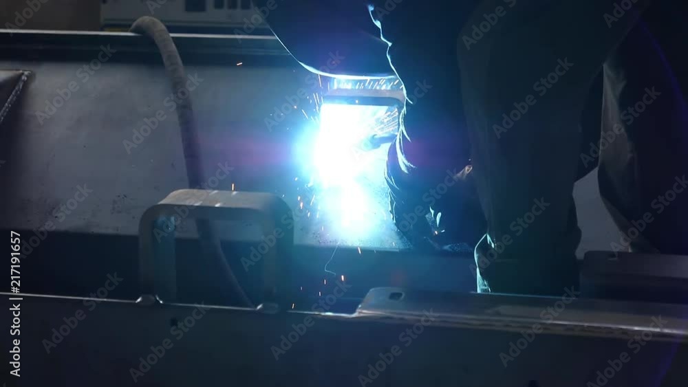 Man welding in a factory, slow motion Man welding in a factory, slow motion