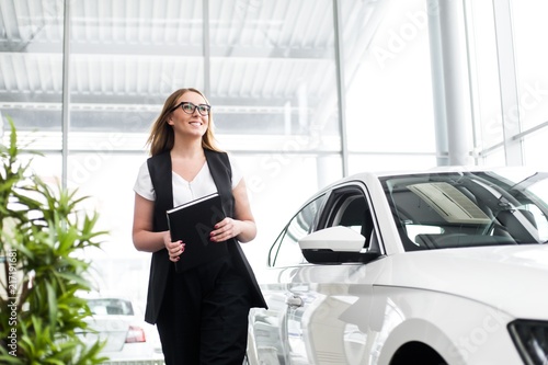 Business woman in glasses with a notebook in the showroom