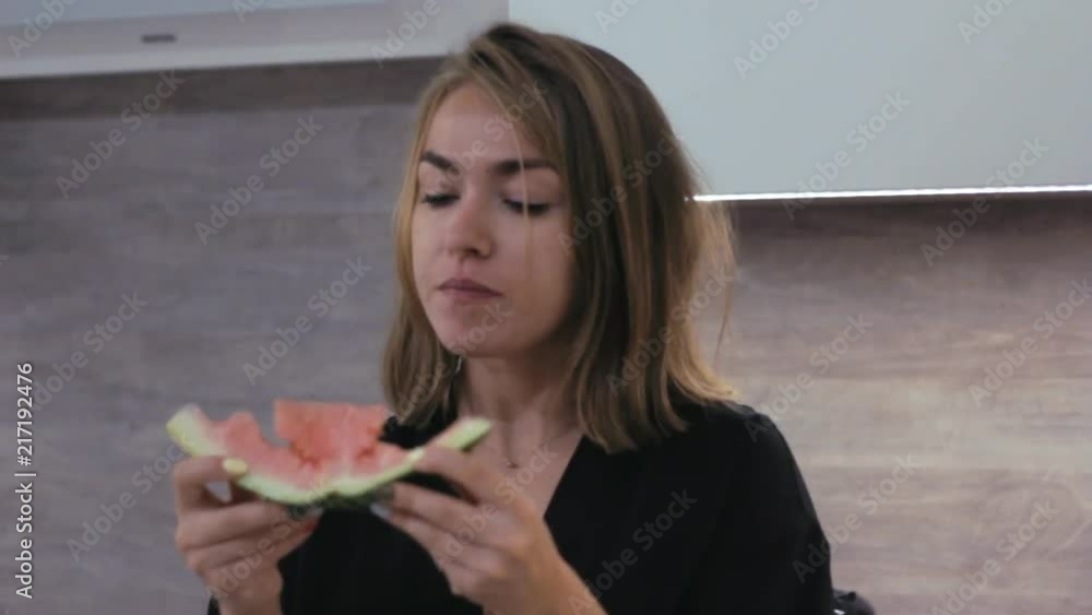 Girl cuts red watermelon with knife and eats it. It tastes so good Girl cuts red watermelon with knife and eats it. It tastes so good