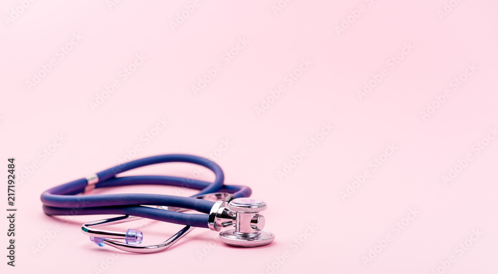 Selective focus of blue stethoscope on pink background. For check heart or health check up concept.. Copy space. Selective focus of blue stethoscope on pink background. For check heart or health check up concept.. Copy space.