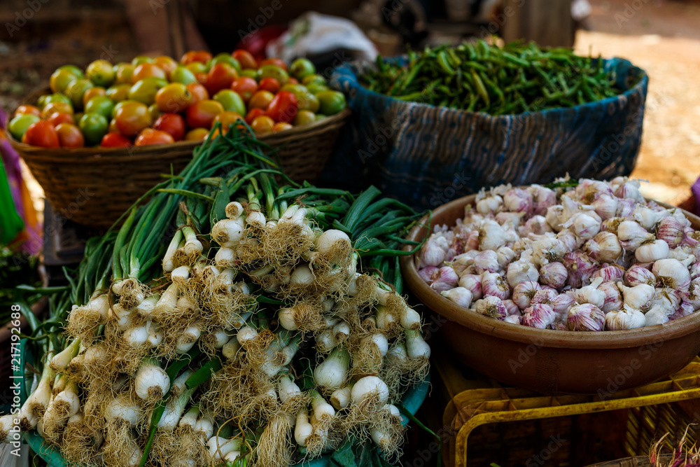 Baskets with fresh vegetables. Green onions, tomatoes, garlic, green beans. Raw food. Baskets with fresh vegetables. Green onions, tomatoes, garlic, green beans. Raw food.