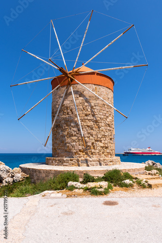 Historic windmill overlooking Mandrakia port. Rhodes island, Greece