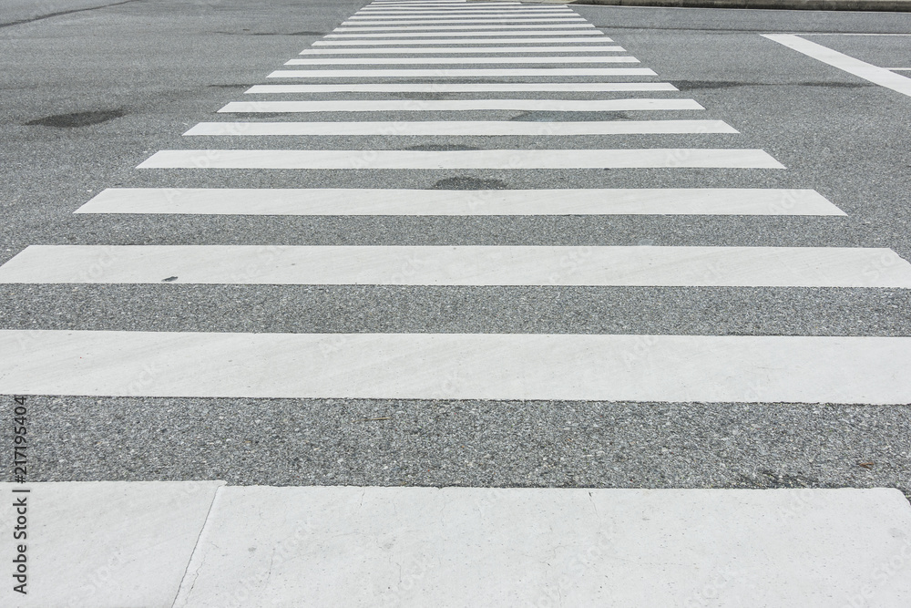 Zebra crosswalk on the road for safety when people walking cross the street, Pedestrian crossing, asphalt road, White lines and crosswalk on street background Zebra crosswalk on the road for safety when people walking cross the street, Pedestrian crossing, asphalt road, White lines and crosswalk on street background