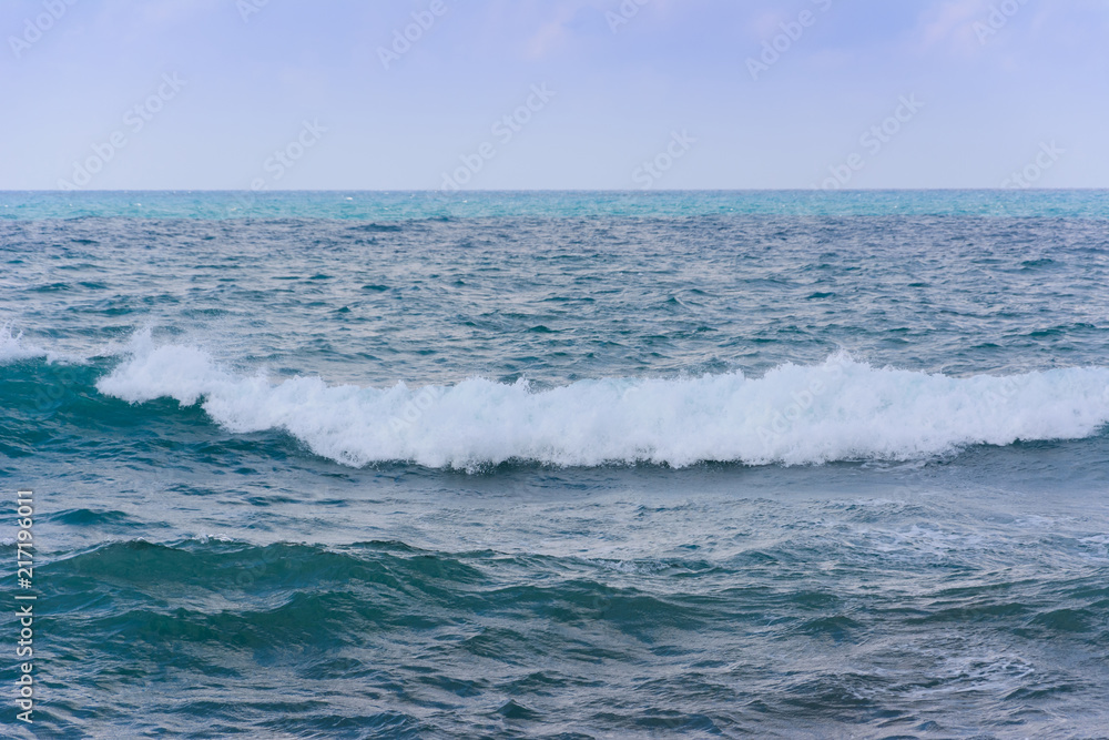 the foamy wave runs along the sea surface
