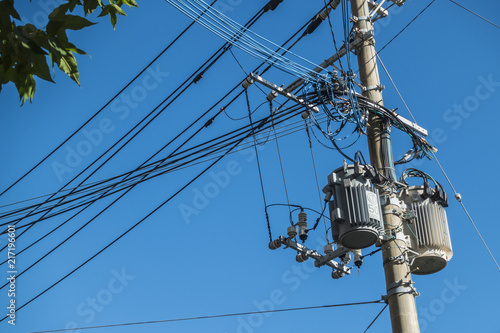 Electric and Utilities Services, Electricity Transformer, Electricity Pole and Cable Wires, Power Utilities and blue sky backgroud, Power Supply with Pole in City, copy space