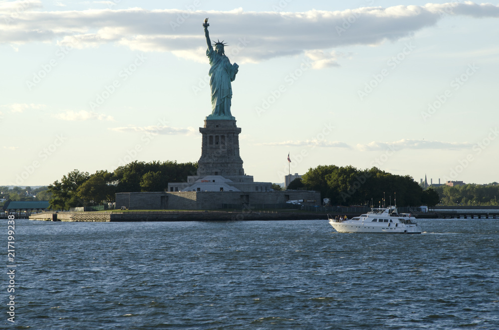 Statue of Liberty and a boat crossing the bay, New York Statue of Liberty and a boat crossing the bay, New York