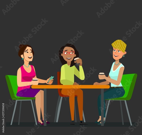Three girls sitting at a table together talking to coffee break.