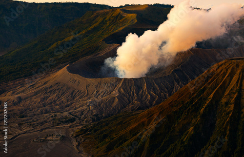 Volcano eruption with the sun shining down on the mountain in morning, Ring of fire zone, Bromo volcano, Java island, Indonesia, Asia. photo