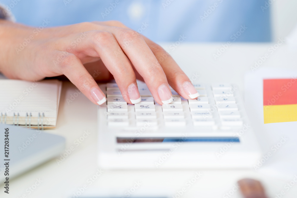 close up businesswoman hand using a calculator in a desk at office at the office and pay attention with the report in the curious situation. Business and finance concepts. close up businesswoman hand using a calculator in a desk at office at the office and pay attention with the report in the curious situation. Business and finance concepts.