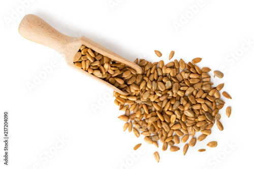 Wallpaper Mural Sunflower seeds scattered with a wooden spoon on a white. The view from the top. Torontodigital.ca