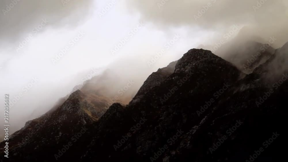 Mountain range covered With windy clouds, slow motion Mountain range covered With windy clouds, slow motion