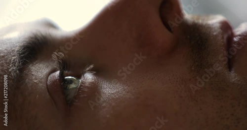 Close-up of man wake up in early morning open eyes