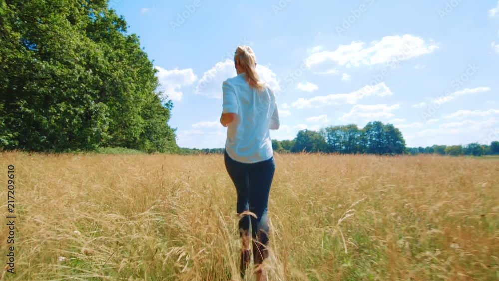 Girl running and jumping in a field with yellow flowers, in the area of Assen, Netherlands. Girl running and jumping in a field with yellow flowers, in the area of Assen, Netherlands.