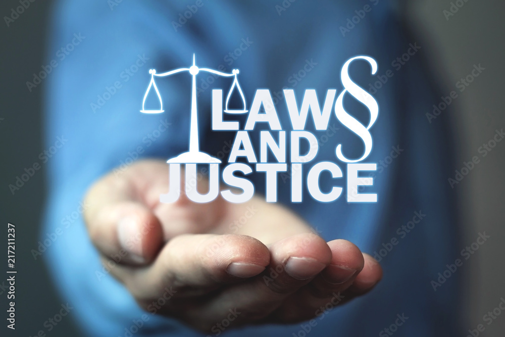 Man holding Law and Justice words with Scales and Paragraph symbol. Man holding Law and Justice words with Scales and Paragraph symbol.