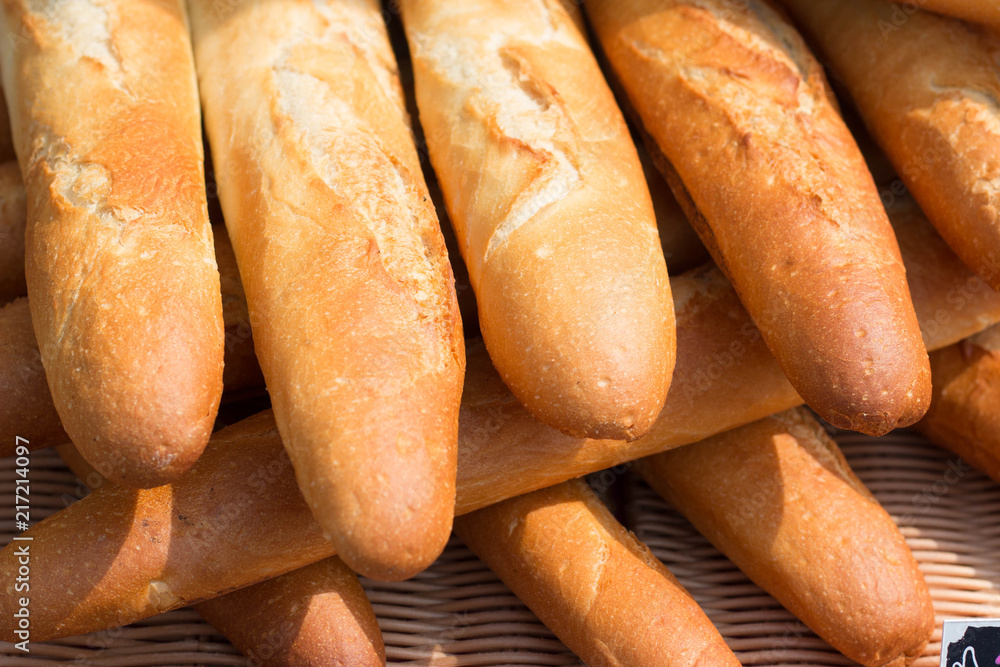 Baguettes, the famous long and thin french bread. Close up of some baguettes in a row.