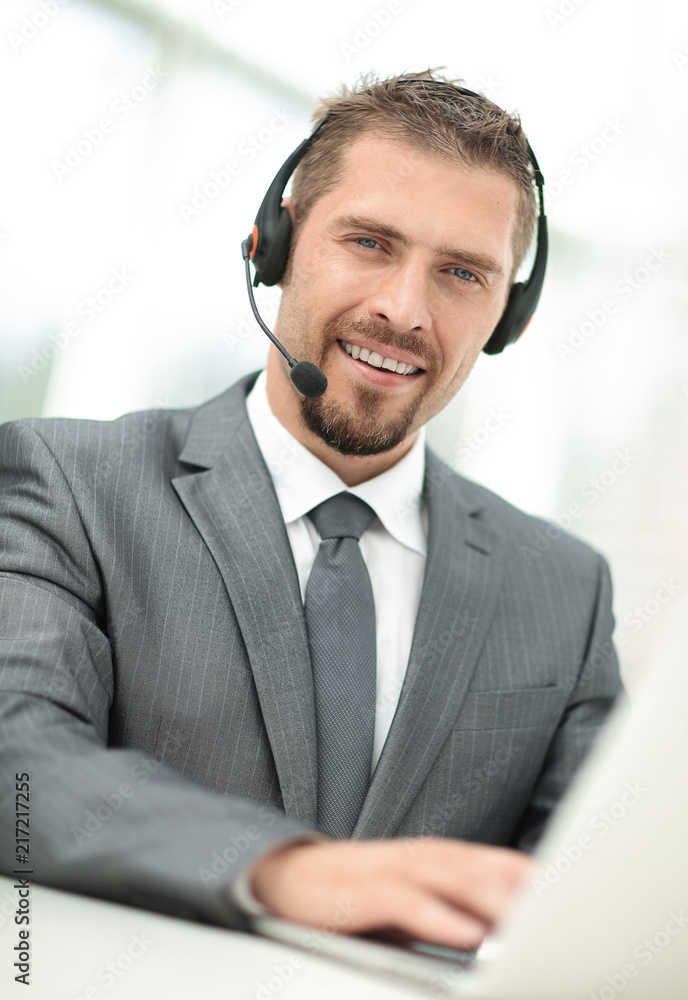 young agent of the call center with the headphones. young agent of the call center with the headphones.