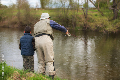 Father and son fishing on the river