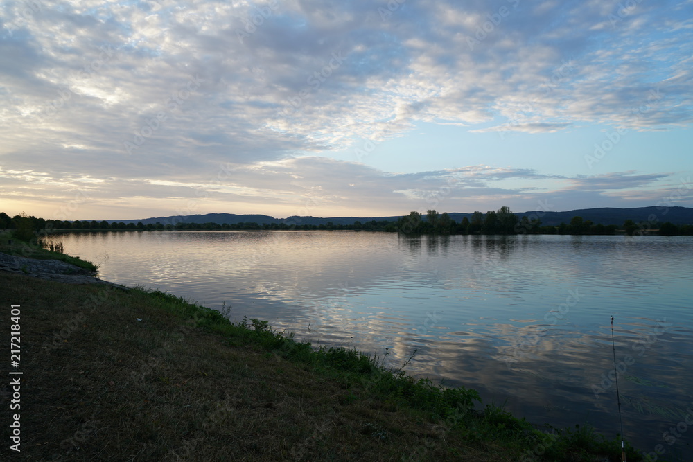 Fishing in Germany on a warm summer evening on the Danube 
